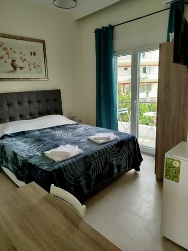 a bedroom with a bed with a blue comforter at Mirkashouse in Limenas