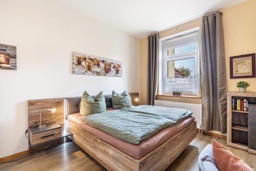 a bedroom with a bed and a window at Ferienhof Schönberg in Lindow