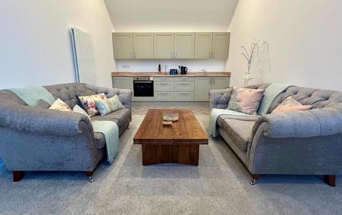 a living room with two couches and a coffee table at Kelsingra Self Catering in Lerwick/Tingwall Airport