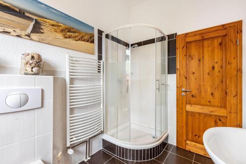 a bathroom with a shower and a sink at Ferienhof Schönberg in Lindow