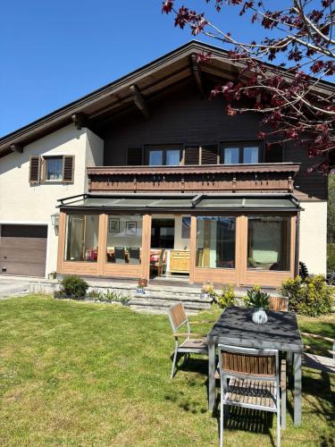 a house with a table and chairs in the yard at Chalet Frieda by Via Montes in Zell am See