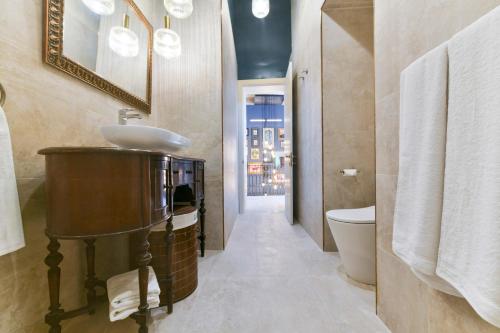 a bathroom with a sink and a toilet at Xewkija Ta' L-Ghagin in Xewkija