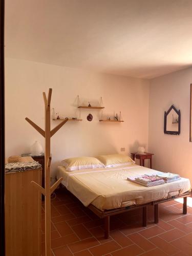 a bedroom with a bed with a cross on the wall at Casa Lago di Brulli in Casole dʼElsa