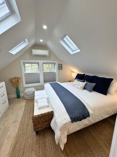 a bedroom with a large bed and a window at Ocean light | Deck + Patio • Central P-Town in Provincetown