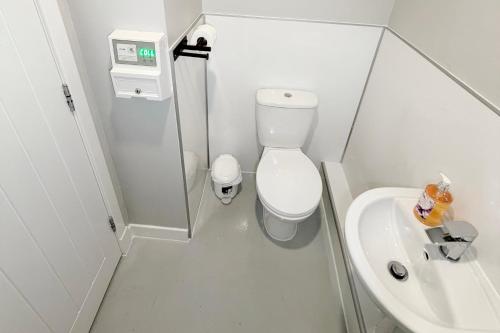a small bathroom with a toilet and a sink at Hopetoun Bothy in Leadhills