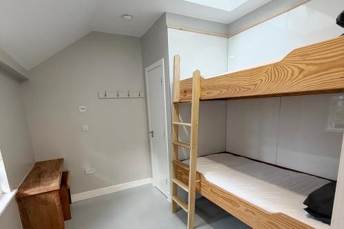 a bunk bed in a room with a ladder at Hopetoun Bothy in Leadhills