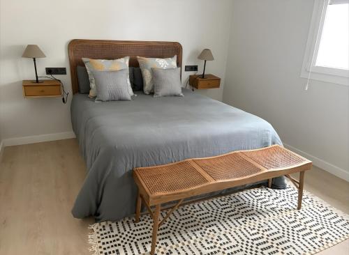 a bedroom with a large bed with a wooden headboard at El Olivo in Níjar