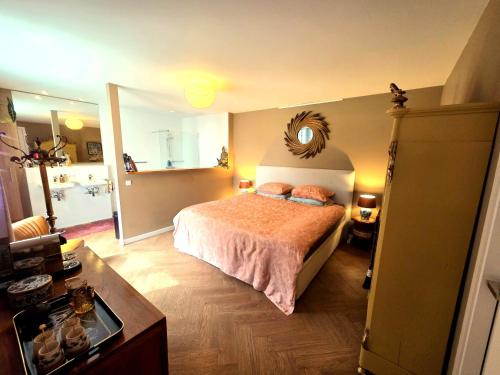 a bedroom with a bed with a mirror on the wall at Villa Oasis in Lelystad