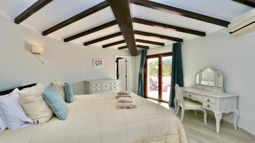a bedroom with a bed and a desk and a mirror at Villa Oasis by Cleverdetails private pool, walk distance in Vilamoura
