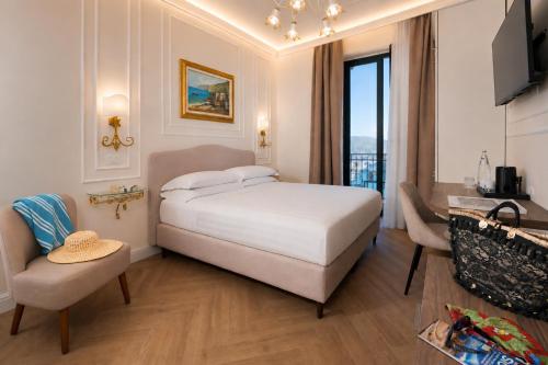 a bedroom with a large bed and a living room at Hotel "La Pensione Svizzera" in Taormina