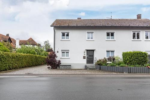 a white house on the side of a street at Fewo Fürst in Moos