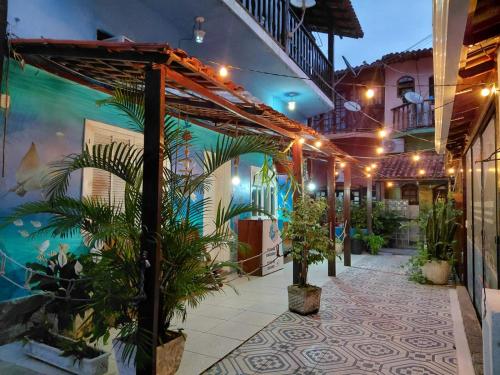 a courtyard of a building with plants and lights at Hostel e Pousada Blue Lagoon in Abraão