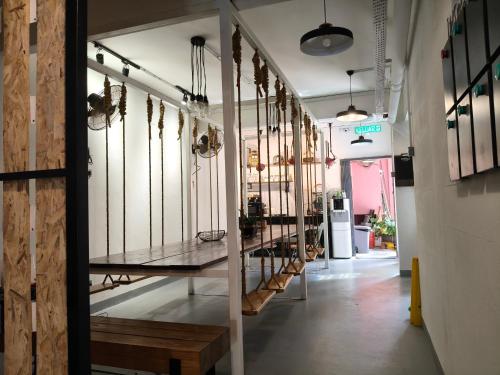 a hallway of a store with a bunch of weapons at The Brownstone Hostel & Space in Ipoh