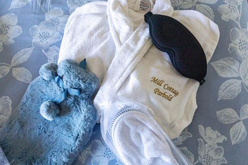 a blue teddy bear laying on a blanket at 'Mill Cottage' Parbold in Parbold