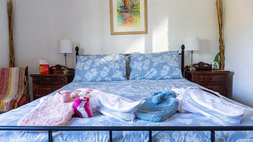 a bed with two stuffed animals on it at 'Mill Cottage' Parbold in Parbold