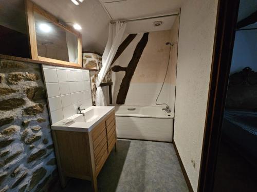 a bathroom with a sink and a bath tub at gite Chèvre in La Chavière