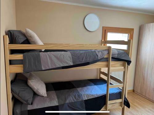 two bunk beds in a room with a mirror at Baita dell'Est in Mese