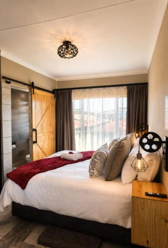 a bedroom with a large bed and a window at Rudman's Private Love Nest in Boksburg