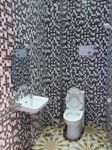 a bathroom with a toilet and a sink at Good Day Kampot Guesthouse in Kampot