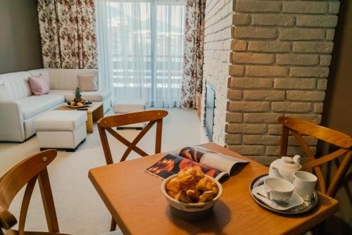 a table with a bowl of food on it in a living room at Green Life Bansko in Bansko