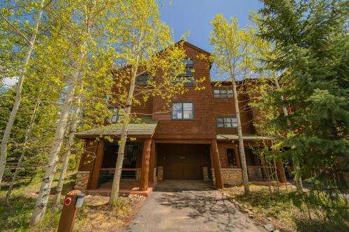 a house in the woods with a driveway at Starfire 1979 by SummitCove Lodging in Colorado in Keystone