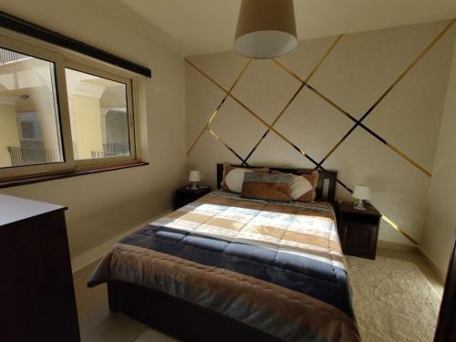 a bedroom with a large bed and a mirror at veranda sahl hasheesh in Hurghada