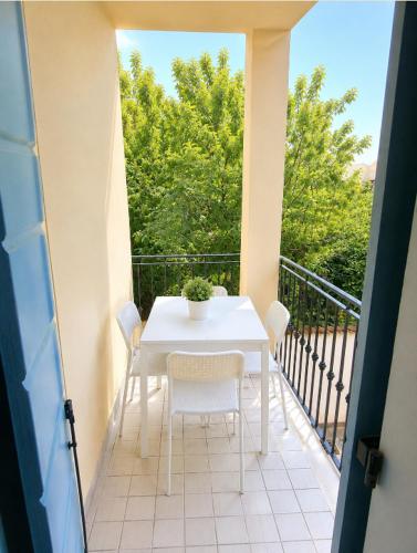 a white table and chairs on a balcony at Casa Incanto - Agenzia Cocal in Caorle