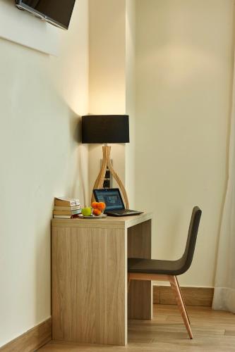 a desk with a chair and a laptop on it at Hotel Bilbao Plaza in Bilbao