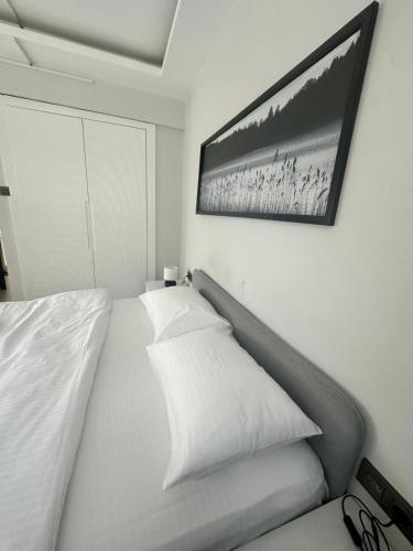 a bedroom with a bed and a picture on the wall at Cicek Apart Hotel in Çeşme