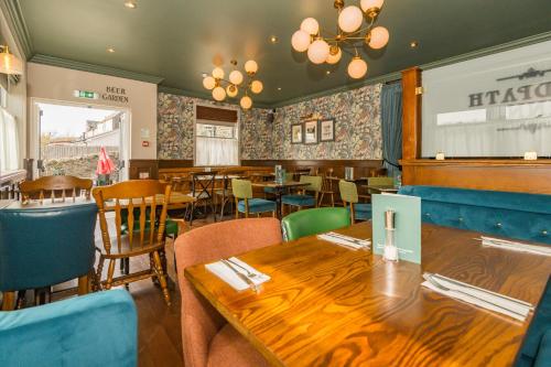 a dining room with tables and chairs in a restaurant at Neidpath inn in Peebles