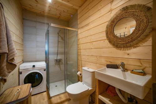 a bathroom with a toilet and a sink and a shower at Redon Marias House 1 in Ágios Matthaíos