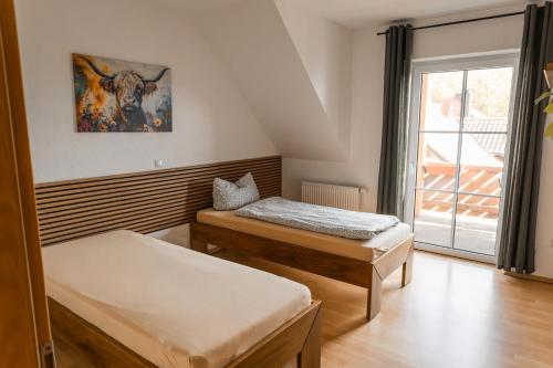 a room with two beds and a window at Ferienwohnung Weigl Komfort in Nittenau