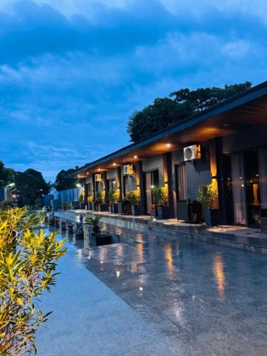 a hotel with a pool at night at DE PORCH in Bolinao