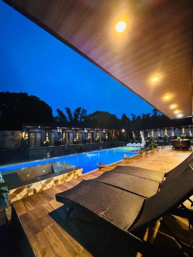 a view of a swimming pool at night at DE PORCH in Bolinao