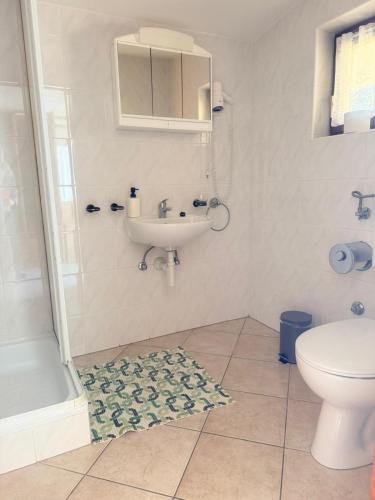 a bathroom with a sink and a toilet at MAAR Kovačić Apartmani in Zaton