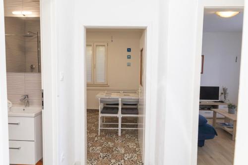 an open doorway to a kitchen with a sink at Sea View apartment 50 m from St Rok Beach in Pučišća
