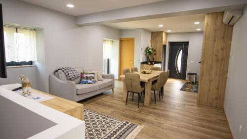 a living room with a table and a dining room at As Casas do Penedo da Moura in Arcos de Valdevez
