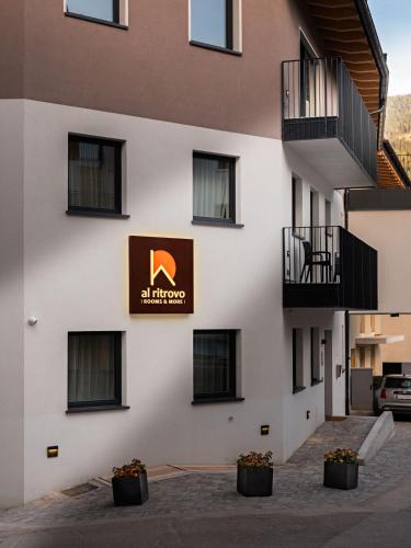 a building with a sign on the side of it at al Ritrovo - rooms & more in Andalo