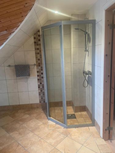 a shower with a glass door in a bathroom at Villa Valdemar in Hammenhög