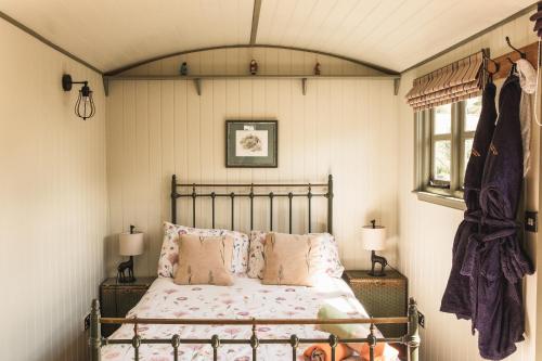 a bedroom with a bed and two lamps and a window at Willows in Rosedale Abbey