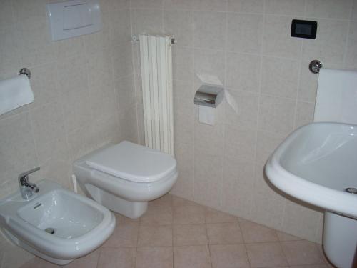 a bathroom with a white toilet and a sink at Hotel Margherita in San Giovanni Rotondo