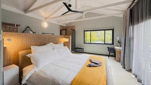 a bedroom with a bed with a hat on it at Fine Stay Clarens in Clarens