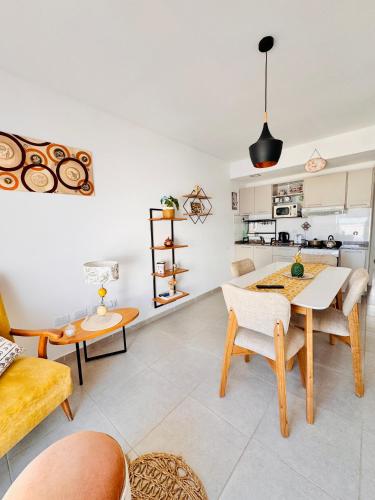a kitchen and living room with a table and chairs at Los Pirineos TC in Junín