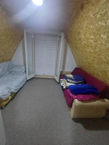 a small attic room with a bed and a bed sqor at Montenegro Mountain Retreat in Podgorica