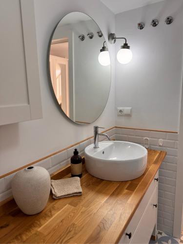 a bathroom with a white sink and a mirror at Casa Feliz in Torrox Costa