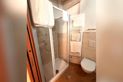 a bathroom with a toilet and a glass shower at Your Charming Amantea Getaway in Amantea