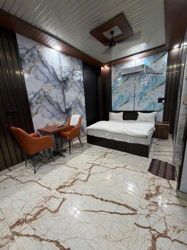 a hotel room with a bed and a table and chairs at Rajstar Resort in Murthal