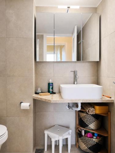 a bathroom with a sink and a mirror at Pinetree House in Nafplio