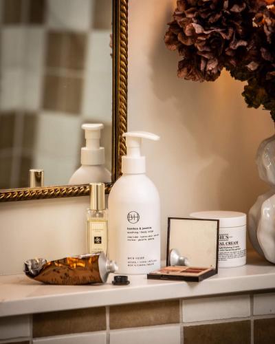 a bathroom counter with a bottle of soap and a mirror at The General Tarleton in Knaresborough