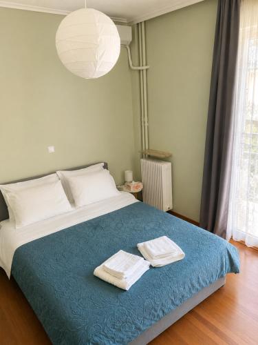 a bedroom with a bed with two towels on it at Pinetree House in Nafplio